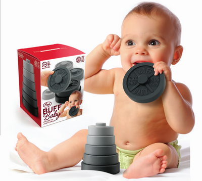 Baby playing with a toy stacker next to its packaging