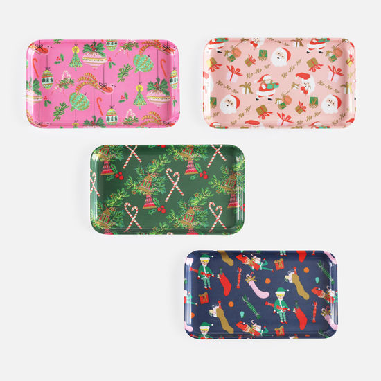 Four different decorative trays with Christmas patterns on a white background