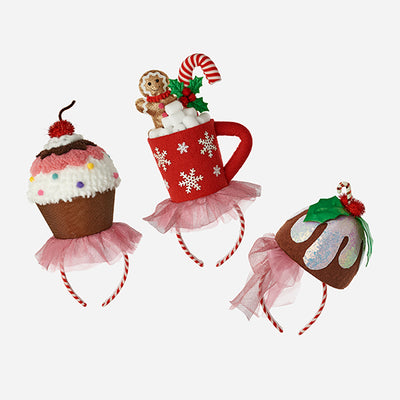 Three festive headbands shaped like a cupcake, mug, and gumdrop on a white background