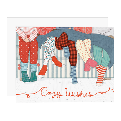 Card illustrated with the legs of 5 people in thick socks and pajamas, with the words "Cozy Wishes" below.